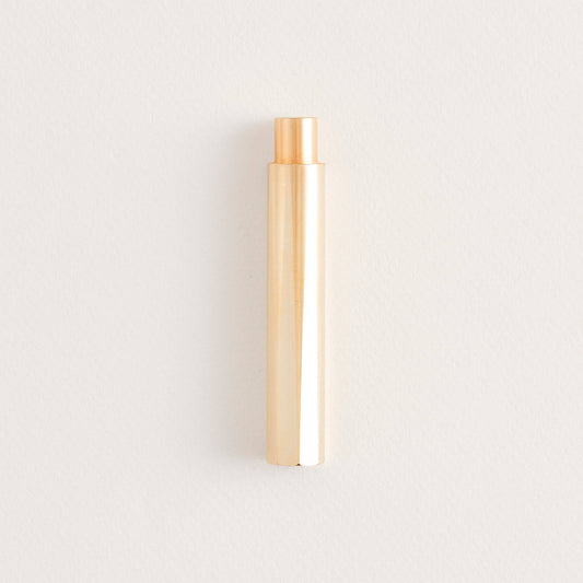 Brass refillable writing pen, cylindrical body with copper-toned tip.