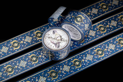 Blue foil washi tape roll and unrolled strip with gold ornate pattern