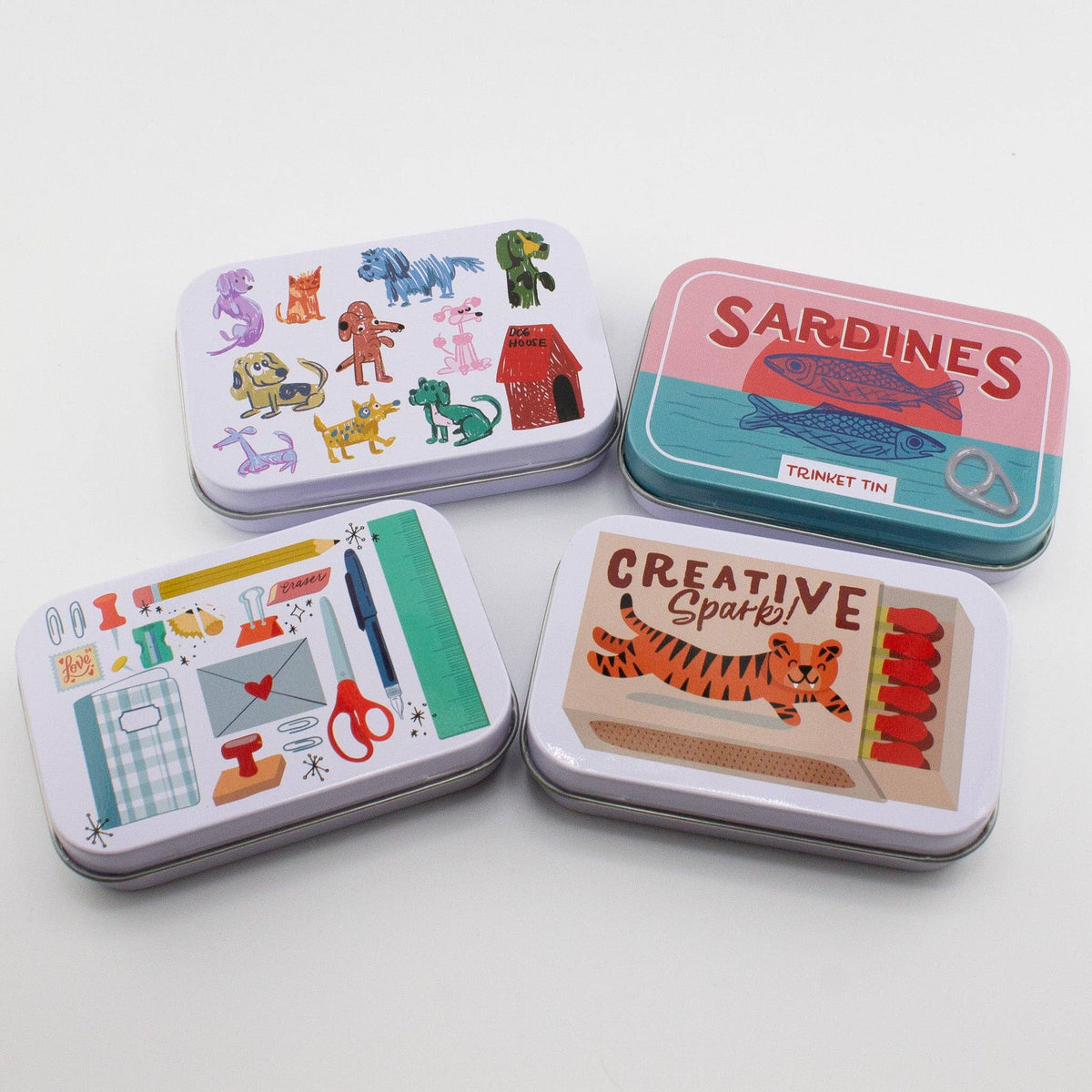 Set of four stationery trinket tins with animal, sardines, and creative label designs