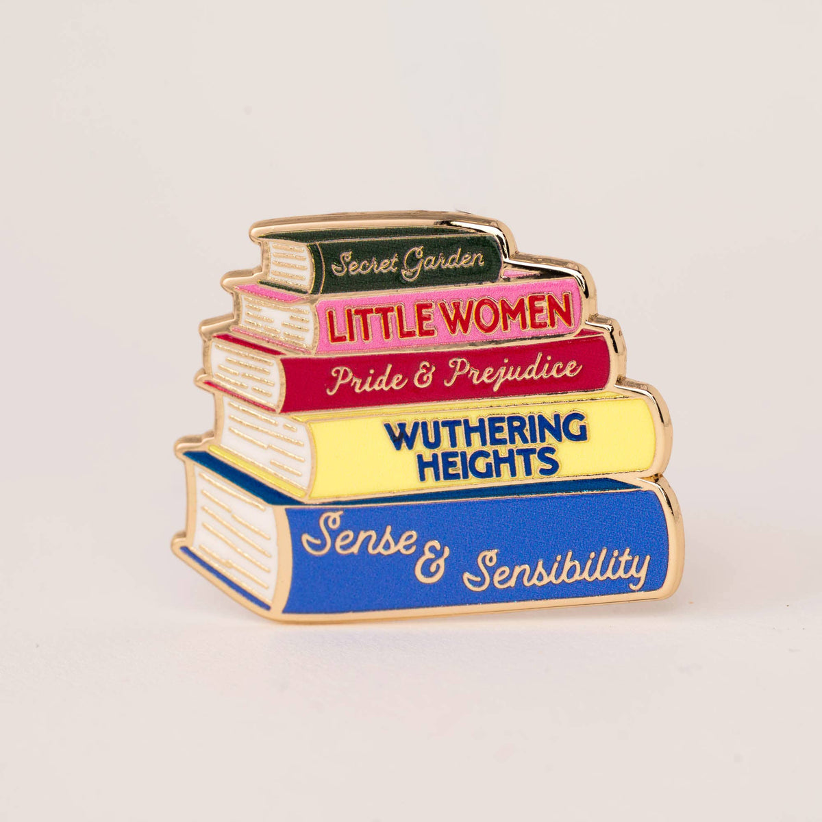 Stacked book enamel pin with titles Little Women, Pride & Prejudice, Wuthering Heights