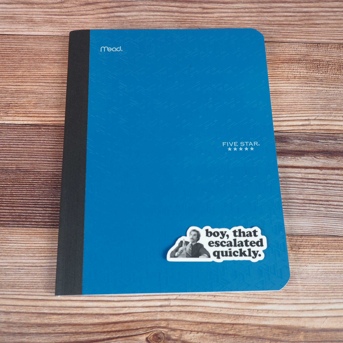 Boy escalated quickly quote sticker on blue notebook cover