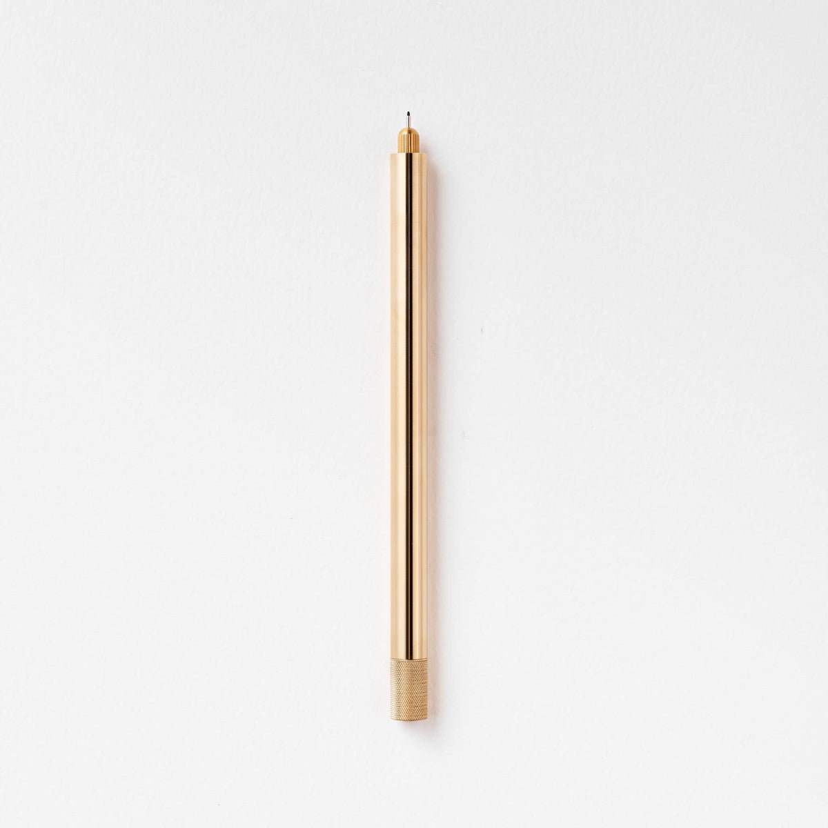 Brass metal pen with pointed nib and ribbed grip band