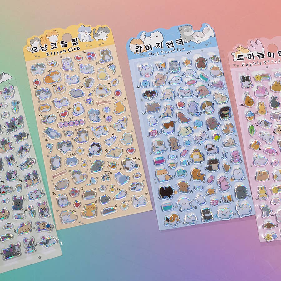 Assorted pastel sticker sheets featuring cartoon cats, bunnies, and small accessory icons.