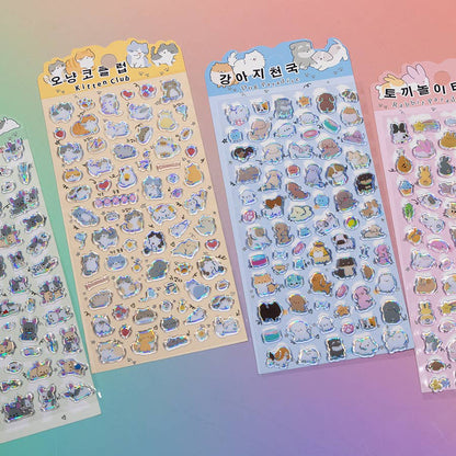 Assorted pastel sticker sheets featuring cartoon cats, bunnies, and small accessory icons.