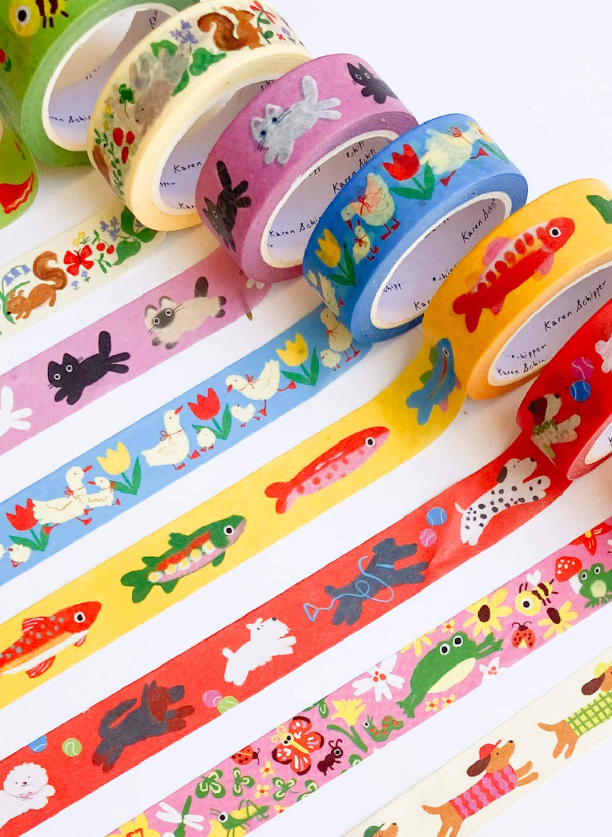 Washi tape rolls and strips featuring colorful animal and floral designs, including dachshunds