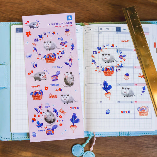 Hangry Opposum clear sticker sheet with colorful opposum, flowers, and label icons