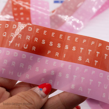 Red and pink kiss-cut PET tape strip with embossed white letter patterns