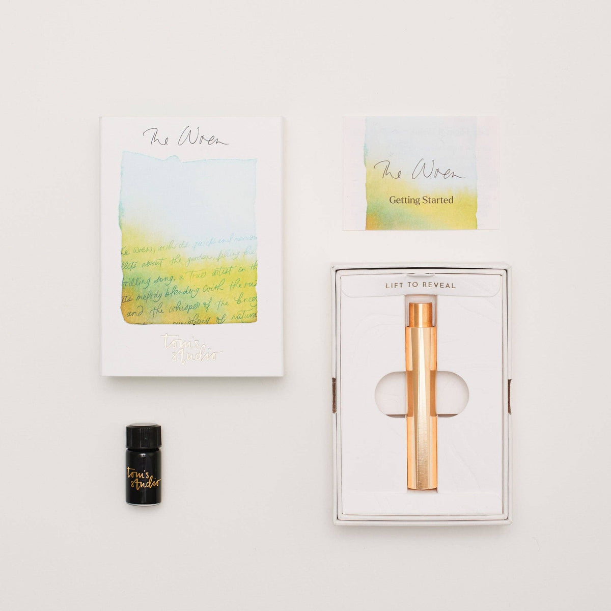 Refillable writing pen in open box with instruction cards and small ink bottle.