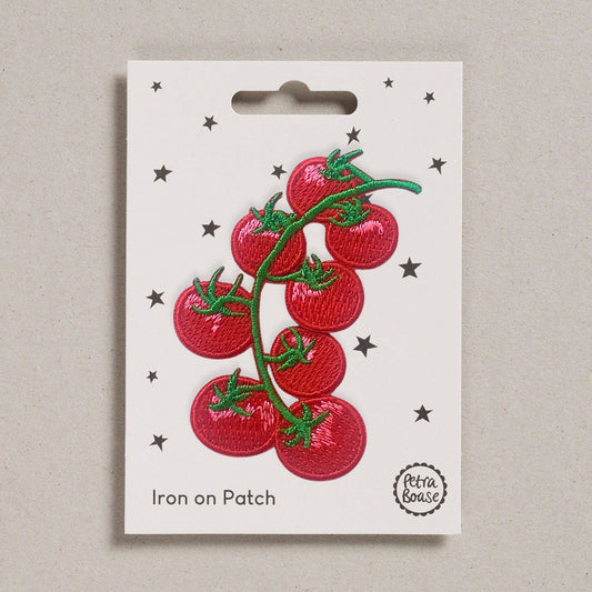 Iron-on embroidered tomato patch with red tomatoes and green vines on retail card