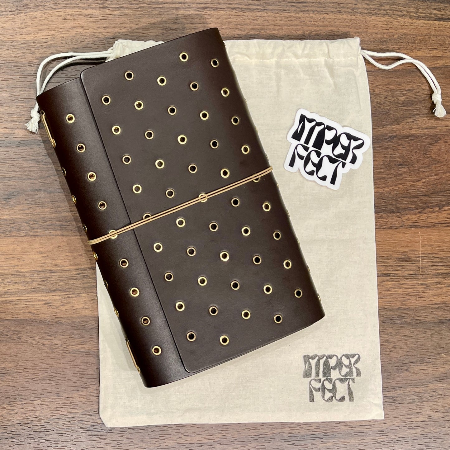 Imperfect Concepts: Thatcher, Dark Brown, Grommet (A5-Bifold) 13B