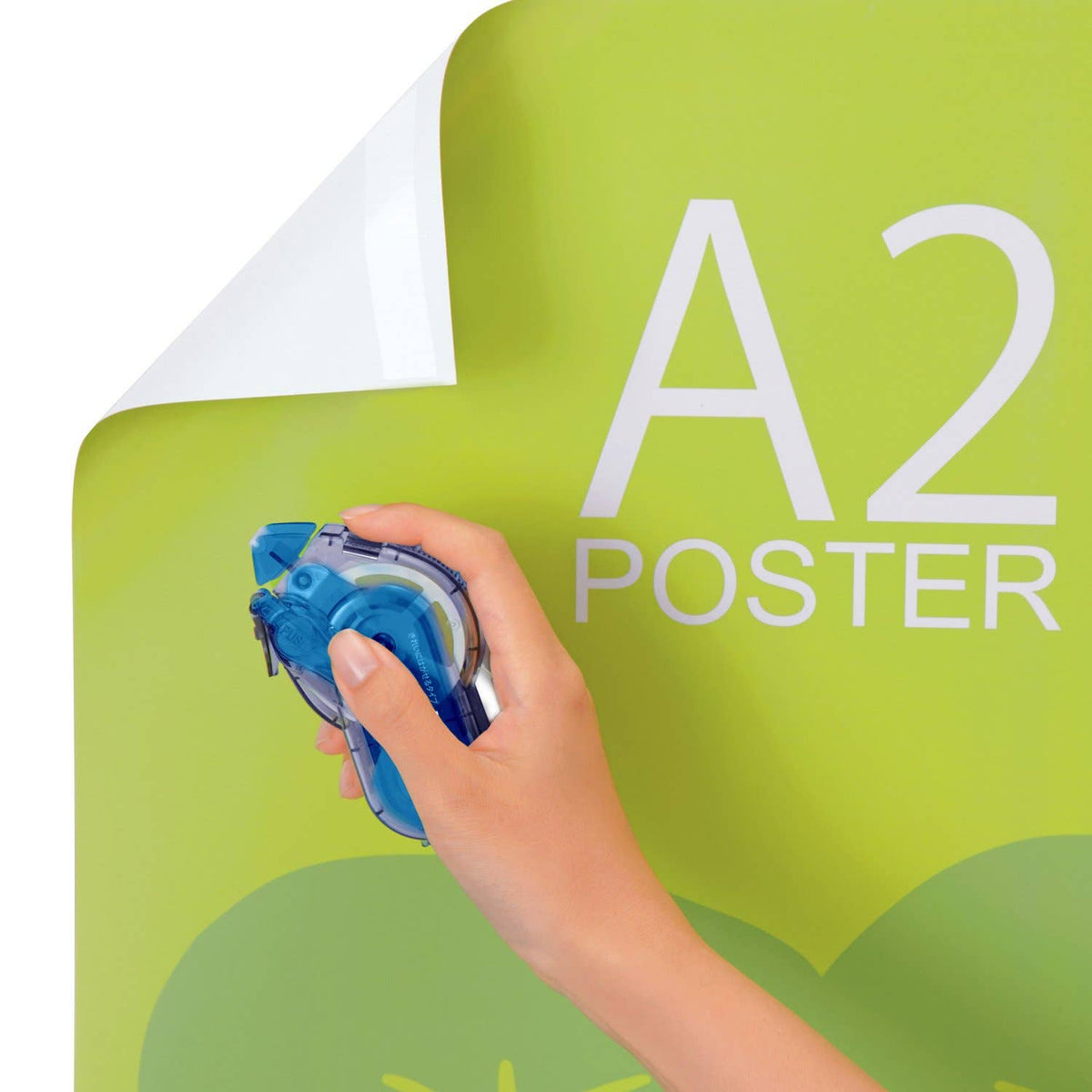 Hand using blue tape dispenser to apply adhesive tape to poster board