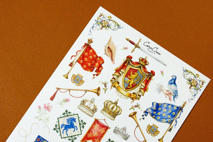 Medieval fable sticker sheet, tilted view, featuring shield crest, crowns, and blue birds.