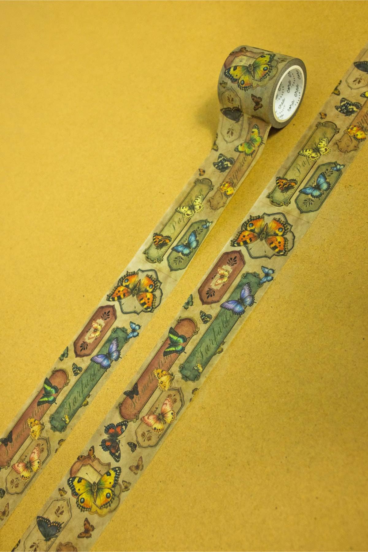 Butterfly washi tape roll showing a long strip of repeating owl, butterfly, and insect icons