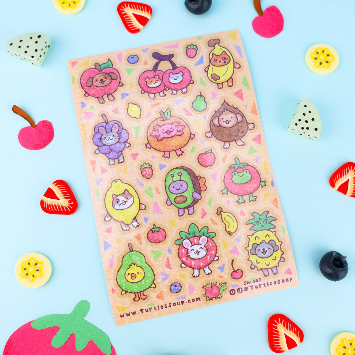Glitter sticker sheet showing colorful fruit animal characters and small icons