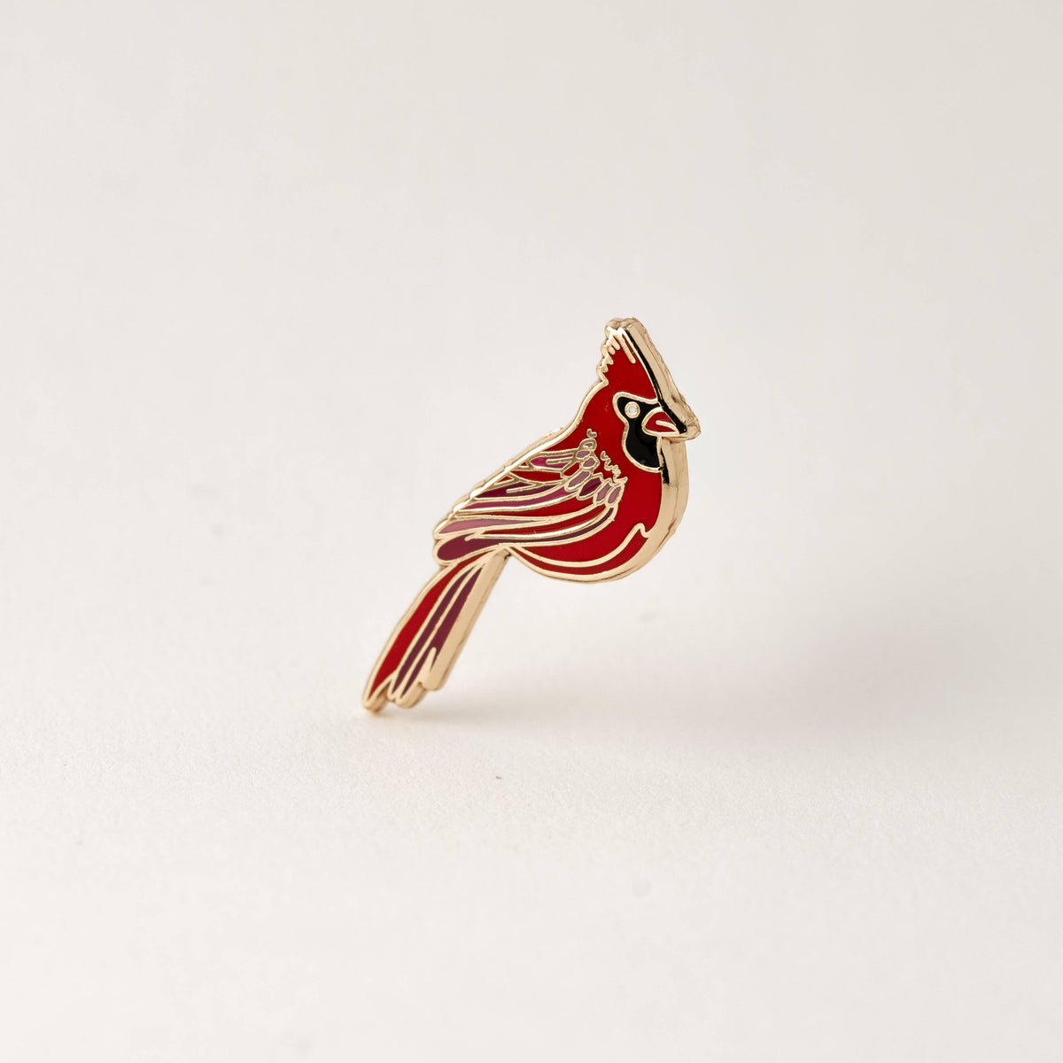 Red cardinal enamel lapel pin with gold-tone edges