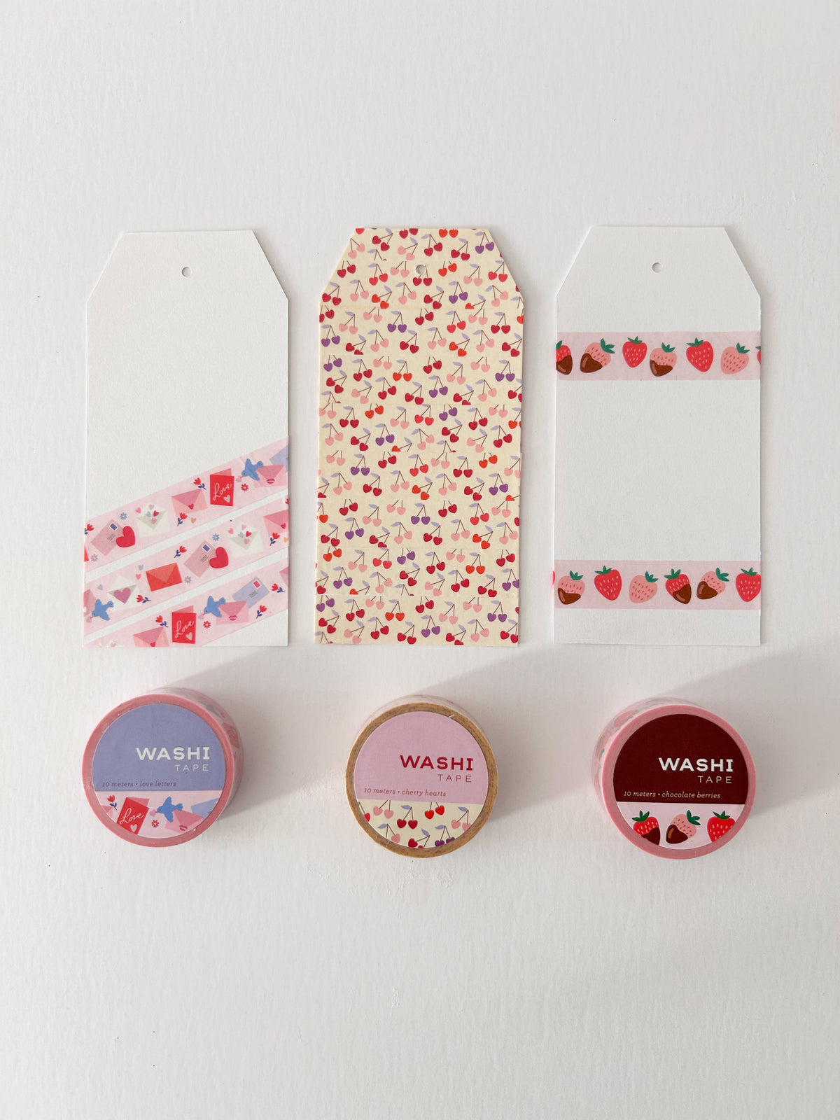 Set of washi tape rolls with strawberry and chocolate berry patterns in boxes