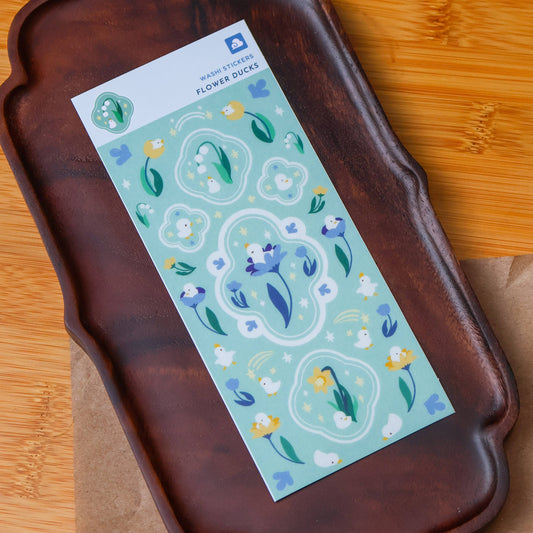 Washi sticker sheet with a blue-green duck and flower motif, shown on a tray