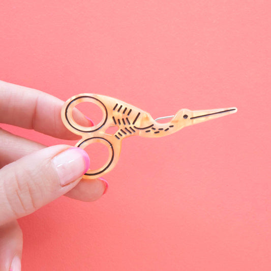 Gold scissors-shaped hair clip with two ring loops for styling hair