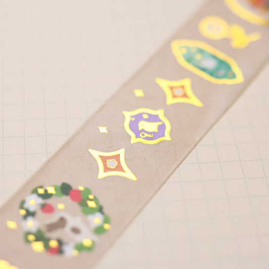 Washi tape strip with gold foil icons and framed animals on tan backing