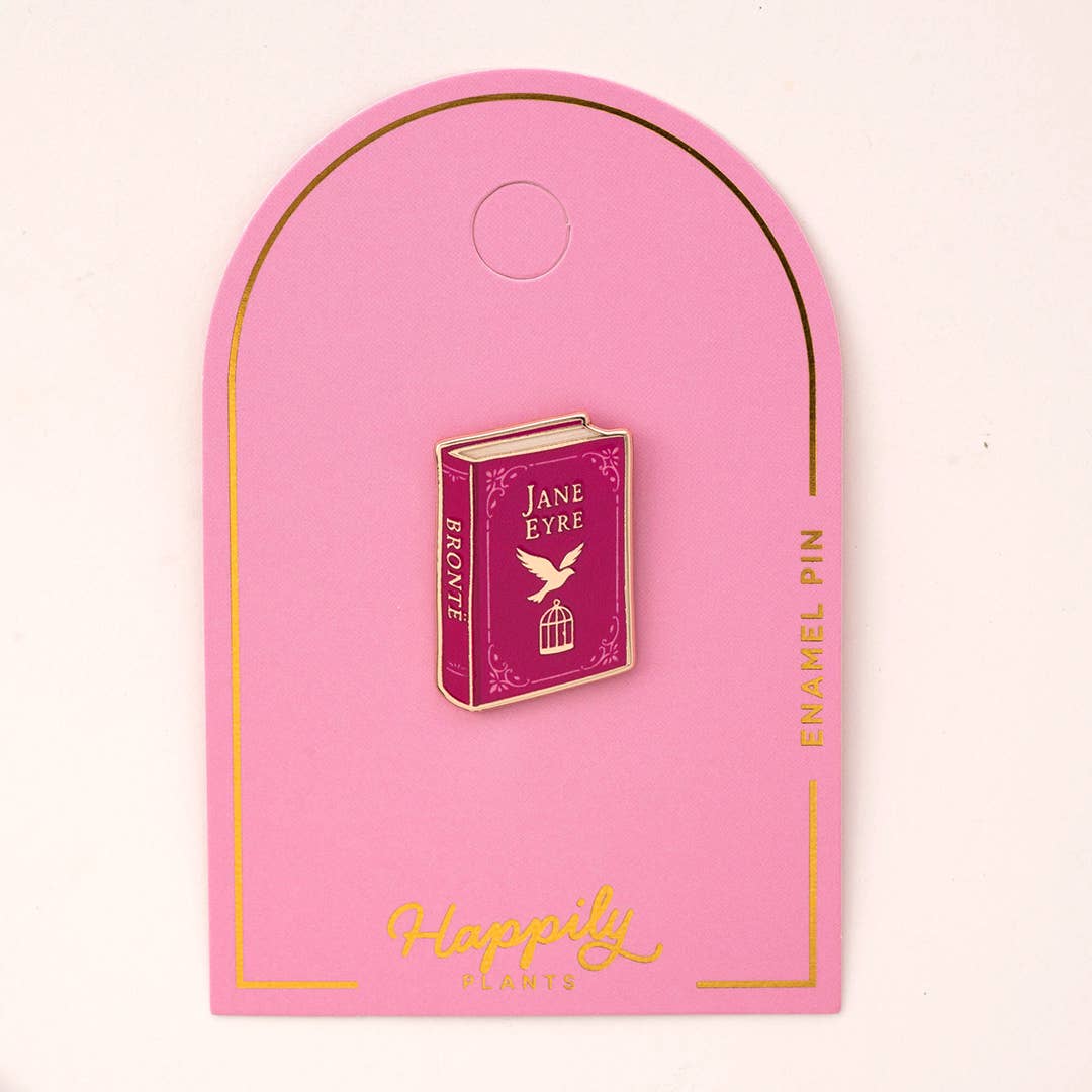 Enamel book pin with maroon Jane Eyre cover on pink backing card, gold border