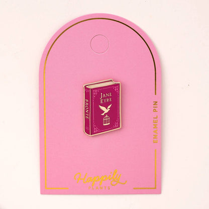 Enamel book pin with maroon Jane Eyre cover on pink backing card, gold border
