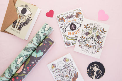 Greeting card with butterfly artwork among other illustrated paper goods.
