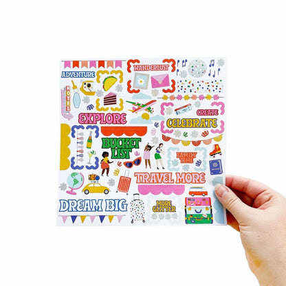 Colorful vision board sticker sheet held in a hand with travel-themed icons