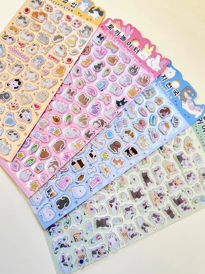 Assorted animal sticker sheets in blue, pink, and yellow with cute character shapes