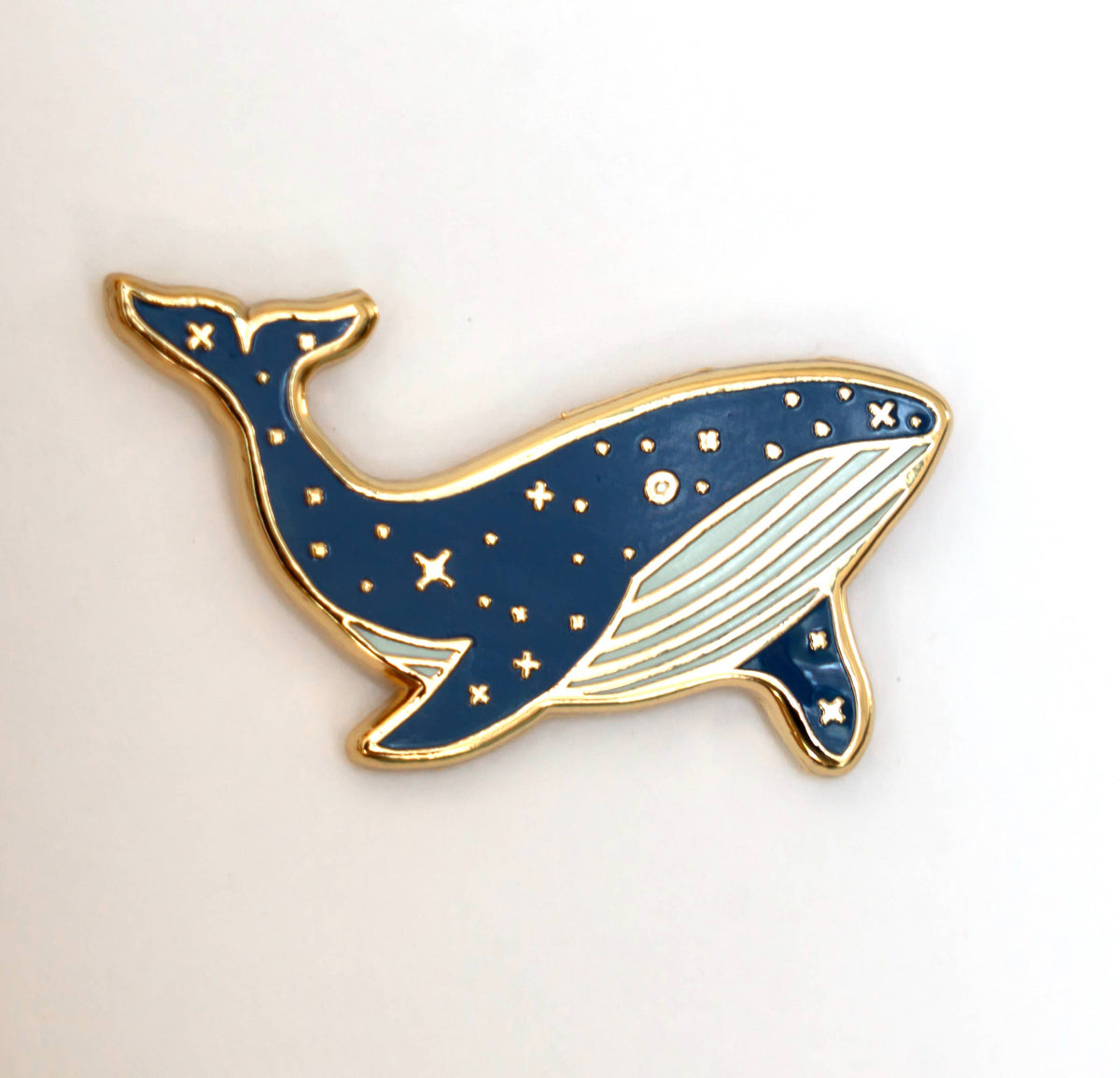 Blue whale enamel lapel pin with white belly and gold border