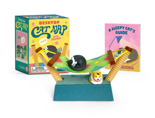 Desktop cat nap toy: black cat figure on teal desk mat with guide cards