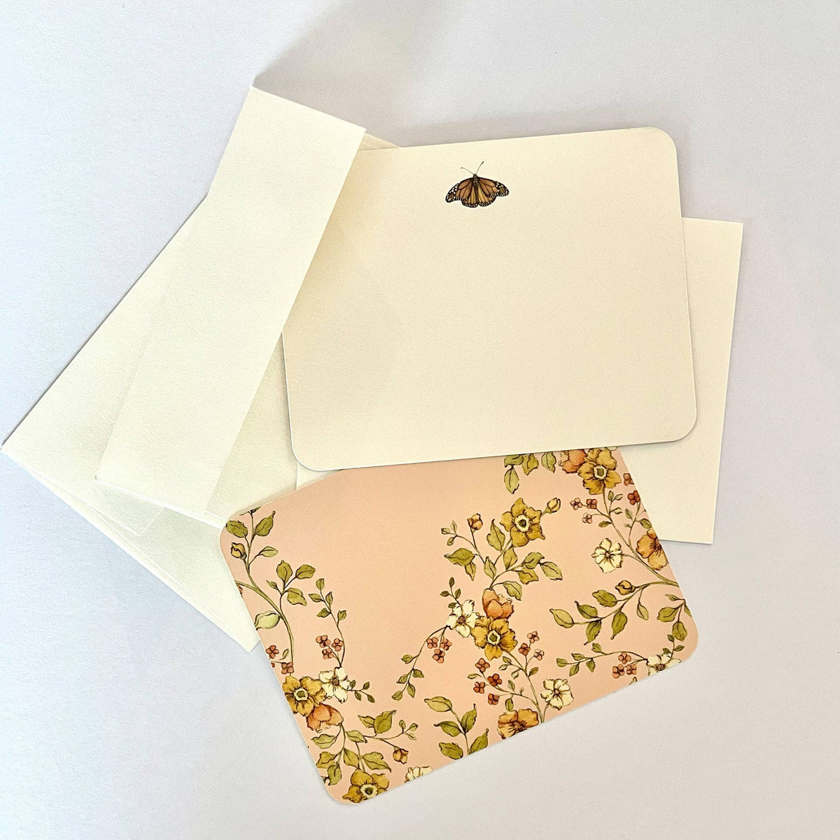 Cream envelope with butterfly motif and botanical floral envelope, with matching blank insert.