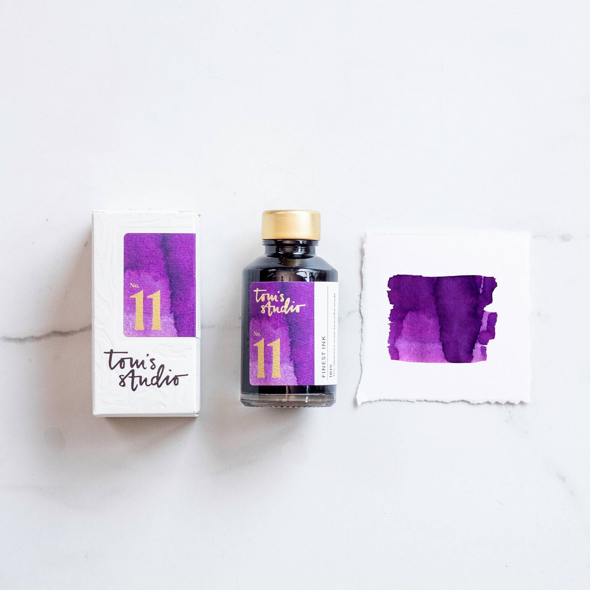 Iris fountain pen ink bottle with purple ink label and two purple ink swatches