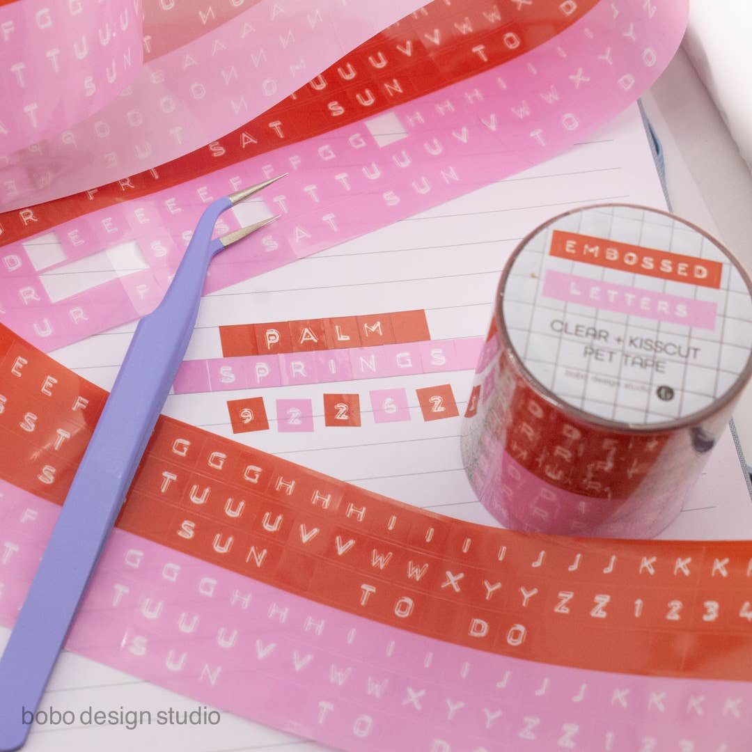 Embossed letter PET tapes in pink and orange with clear backing and roll