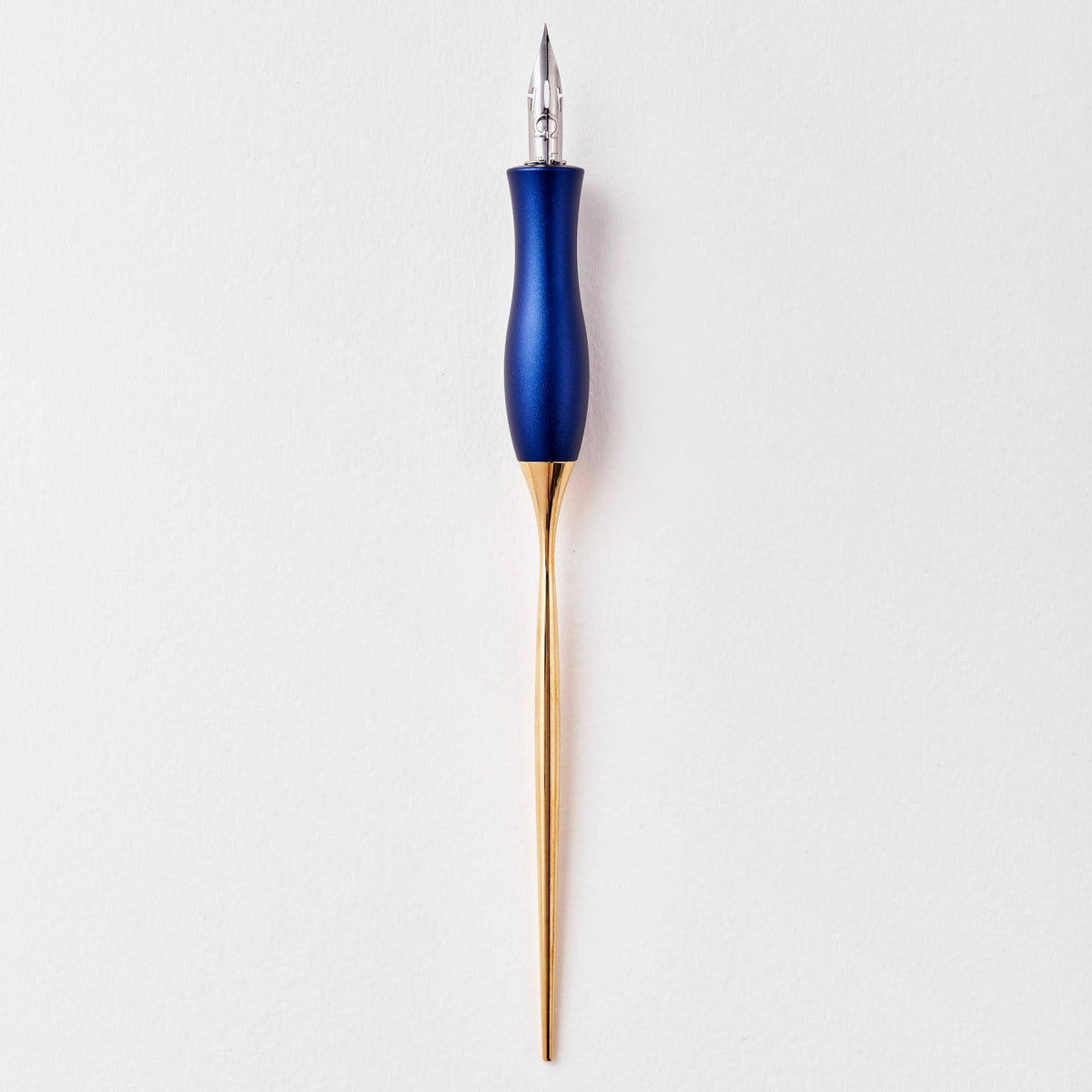 Navy calligraphy pen with oblique nib and gold accents, upright close-up