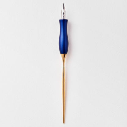 Navy calligraphy pen with oblique nib and gold accents, upright close-up