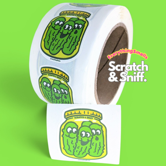 Scratch-and-sniff sticker roll with green pickle icons and 'Scratch & Sniff'