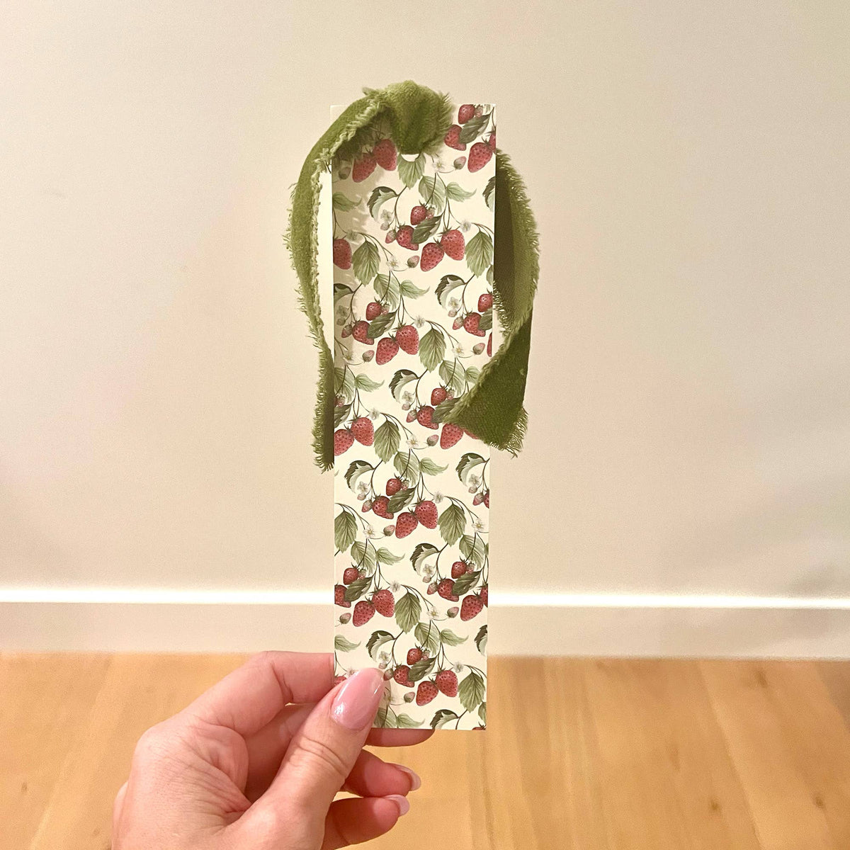 Double-sided strawberry bookmark with green velvet ribbon trim and fruit pattern