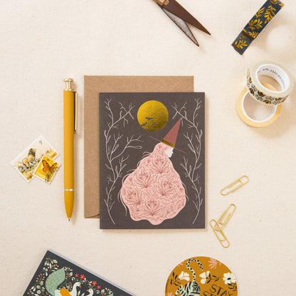Witch greeting card with gold moon and kraft envelope, shown with stationery accessories