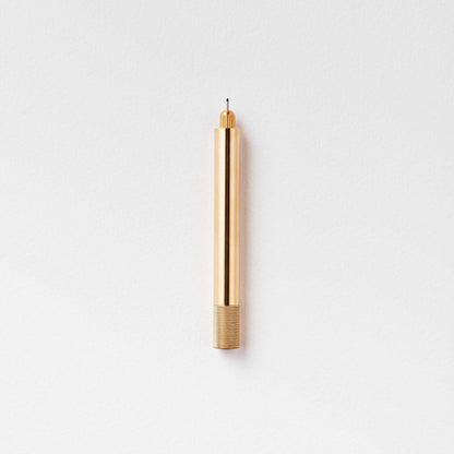 Brass metal pen with pointed nib and ribbed base grip
