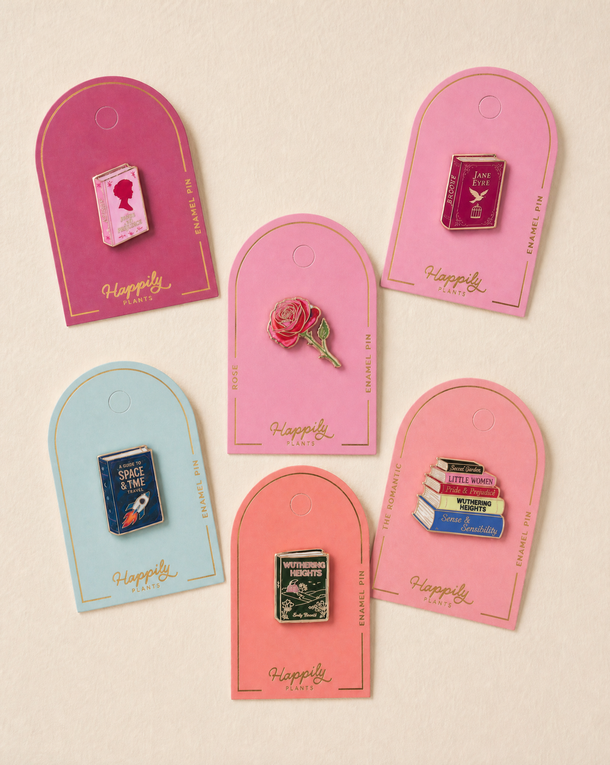 Set of enamel book pins on pink and blue 'Happy' display backing cards