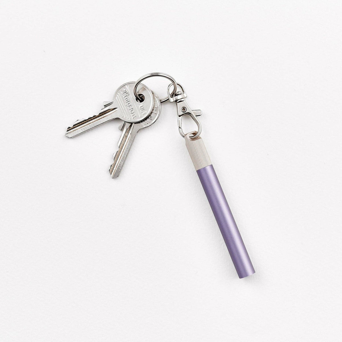 Purple keychain pen with metal keyring, attached keys, and key loop