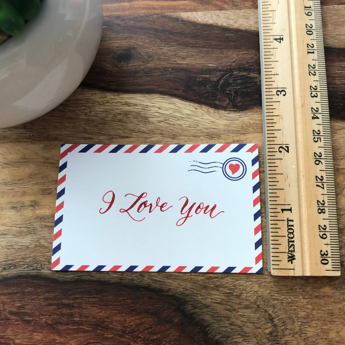 Airmail mini notecard with “I Love You” message, shown beside a ruler