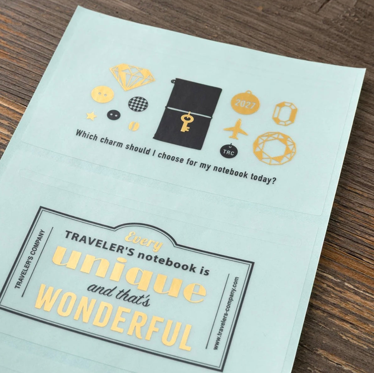 Charm icon sticker sheet with airplane, key, and “Every Traveler’s notebook is unique” text