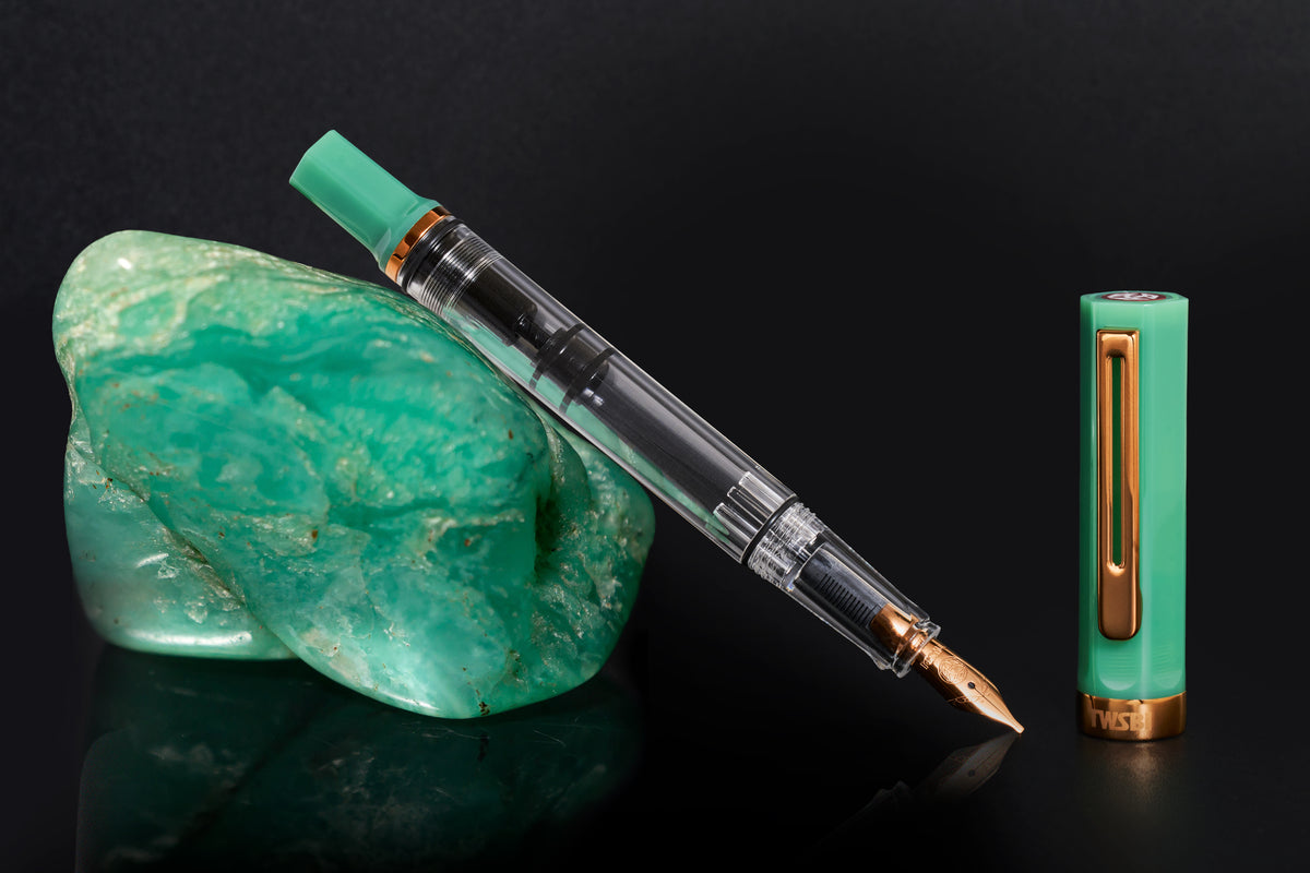Jade green marbled fountain pen with bronze nib, clip, and barrel window