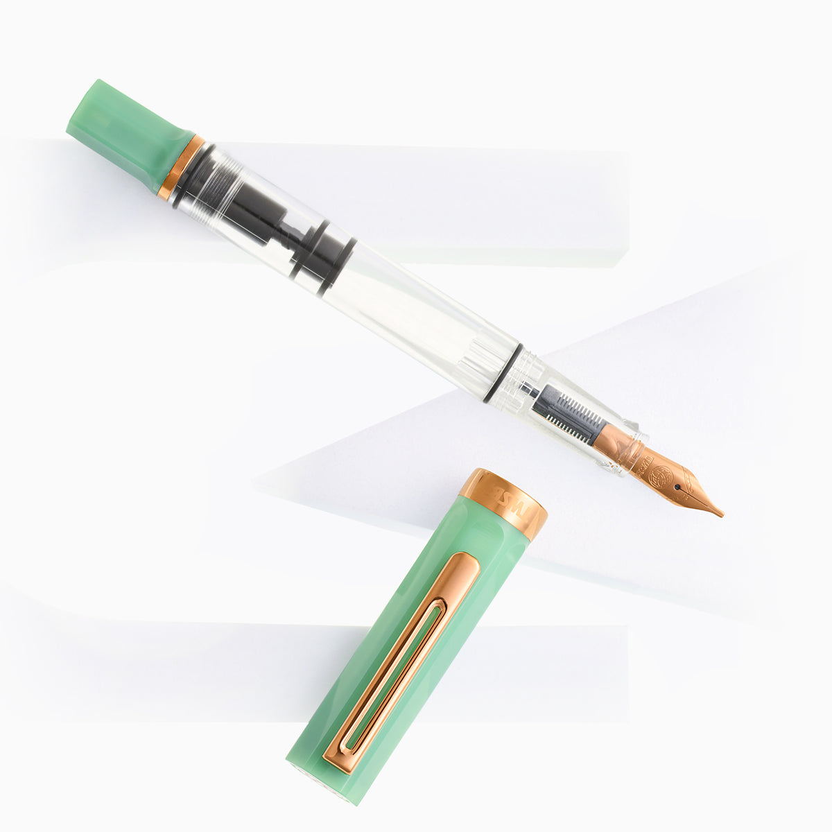 Jade green transparent fountain pen with bronze nib and cap accents