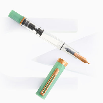 Jade green transparent fountain pen with bronze nib and cap accents
