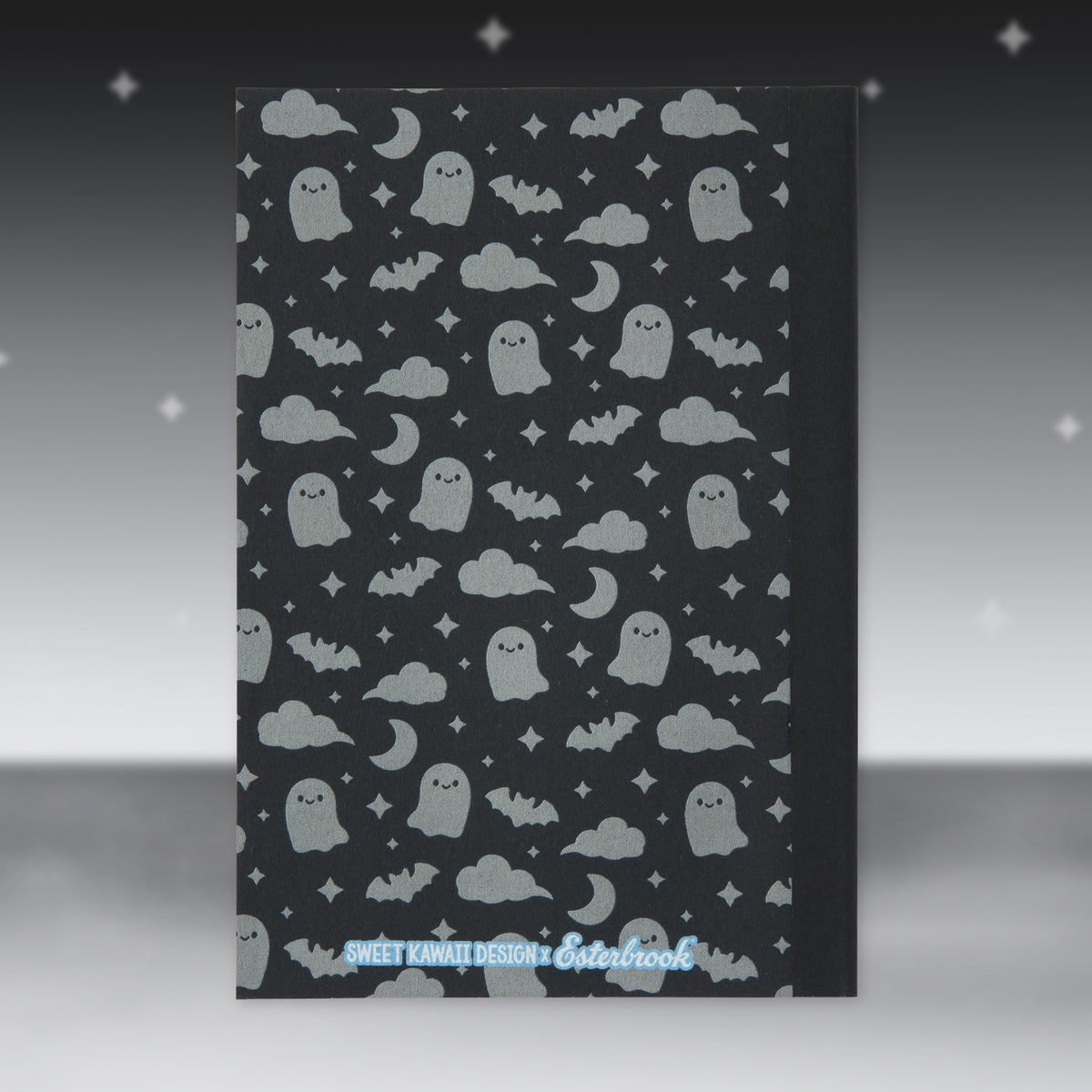 Black Halloween patterned paper sheet with ghost faces, clouds, and stars