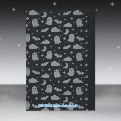 Black Halloween patterned paper sheet with ghost faces, clouds, and stars