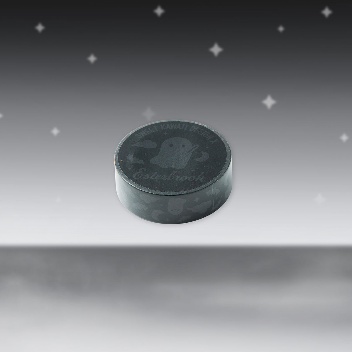 Gray washi tape roll with dark ghost pattern