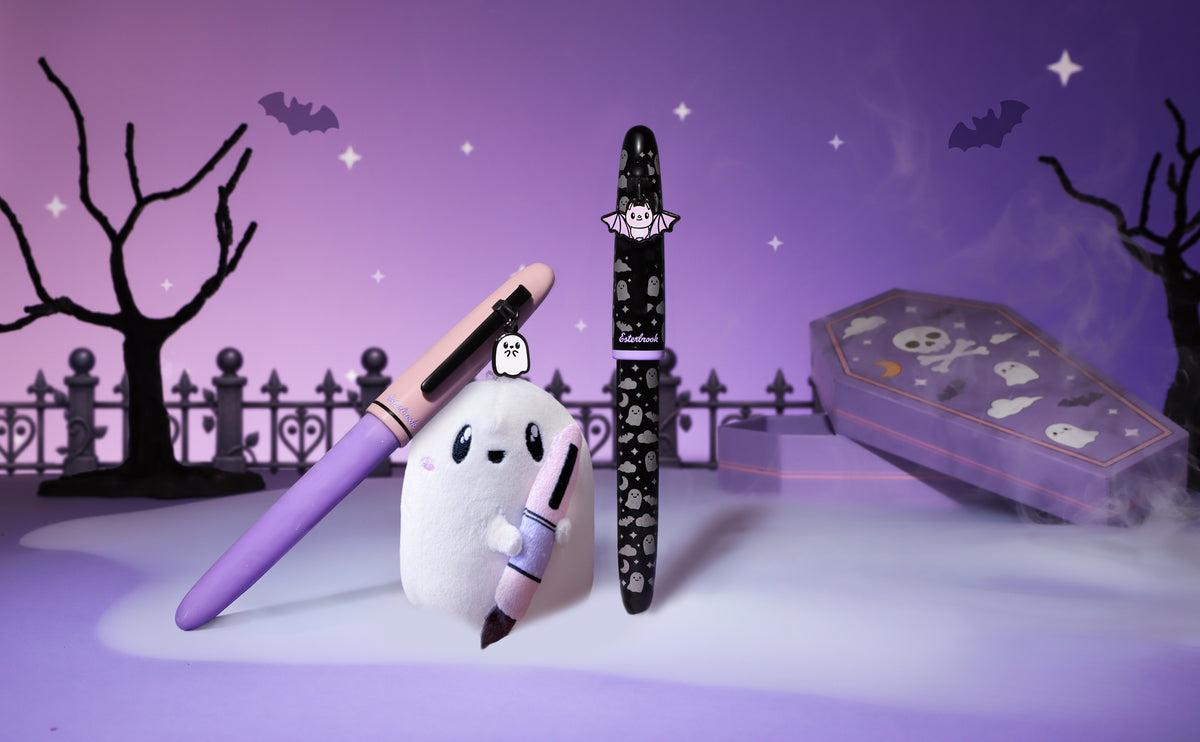 Decorative fountain pens with pastel purple and black patterns plus plush ghost holder
